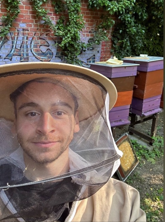 Wearing a beekeeper's hat, visiting a friend's beehives